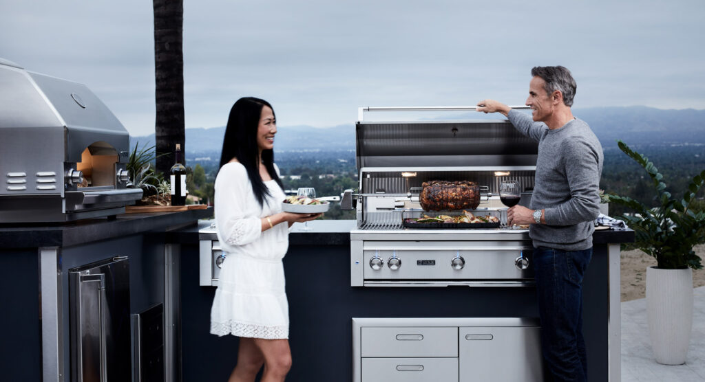 couple enjoying their outdoor kitchen