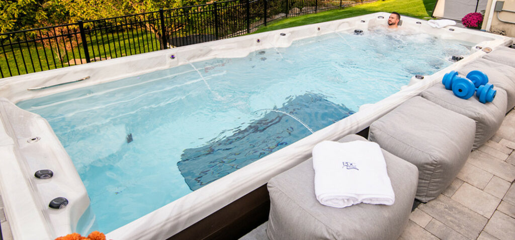 outdoor swim spas - man enjoying a hydromassage in a swim spa