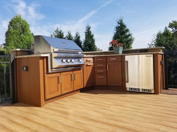 brown outdoor cabinets with BBQ and fridge
