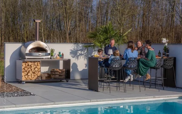 family enjoying their outdoor pizza oven